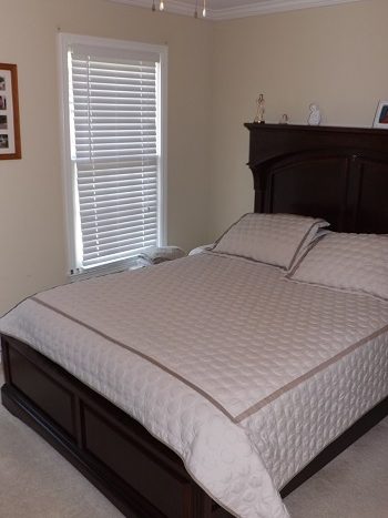 Large 2nd guest bedroom with neutral colors, wall to wall carpeting and ceiling fan.