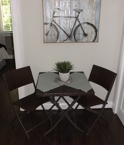 Breakfast nook with hardwood floors and crown moldings