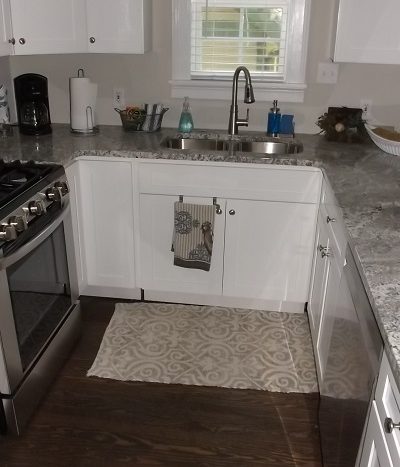 Kitchen with granite counters, stainless steel appliances, hardwood floors