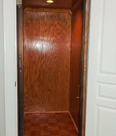 elevator with custom wood walls and secure locking features