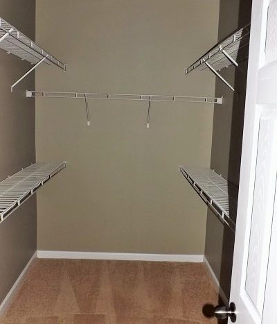 large custom closet with carpet and built in shelving