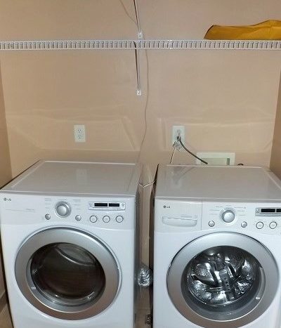laundry room with washer and dryer units included